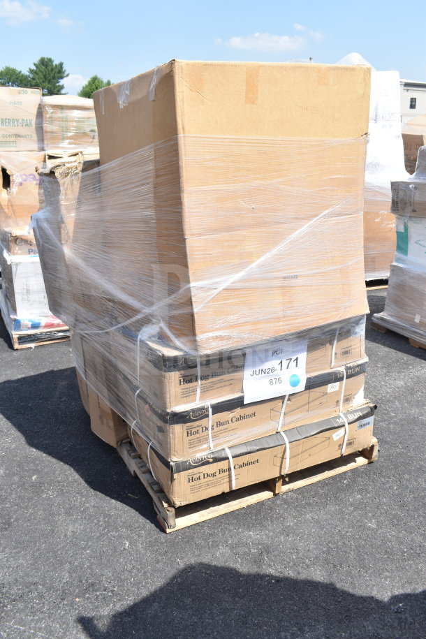 Stack of 9 new scratch and dent items on a pallet, including hot dog bun boxes. Labeled "JUN26-171." Wrapped in plastic.