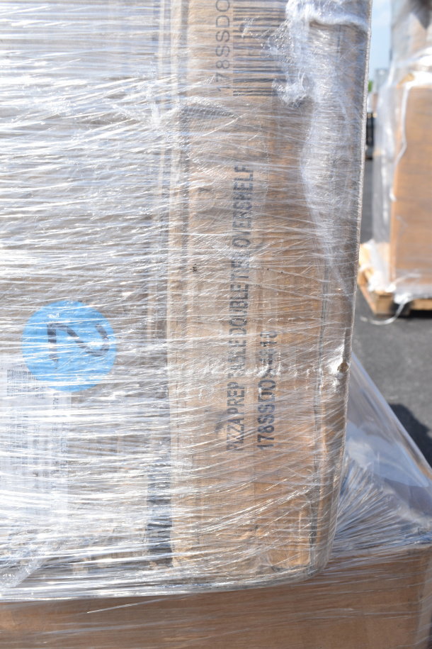Pallet with 9 new scratch and dent items, including bun boxes and trays, wrapped in plastic. Visible label: "Pizza Prep".