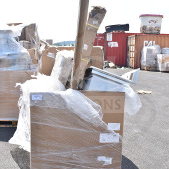 Brand new scratch and dent items on pallets, including a cart, tabletop, and sink. Wrapped in plastic with visible labels.