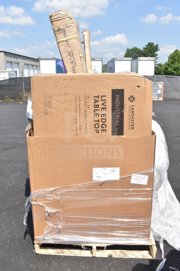 Stack of eight new scratch-and-dent items, including a Lancaster live edge tabletop, visible in damaged packaging.