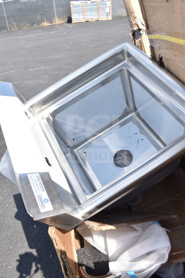 Stainless steel sink with visible scratch and dent damage in packaging, Steelton label attached.
