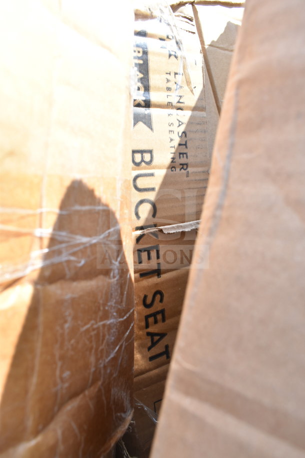 Box with visible marking "Lancaster Table & Seating Black Bucket Seat," indicating scratch and dent condition.