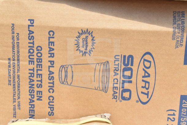 Cardboard box labeled "Dart Solo Ultra Clear" containing clear plastic cups, 20 oz capacity.