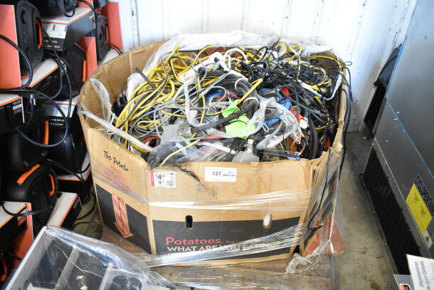 Lot of various cables in a large cardboard box marked "Potatoes." Includes power cords and assorted wiring. Condition: Used.