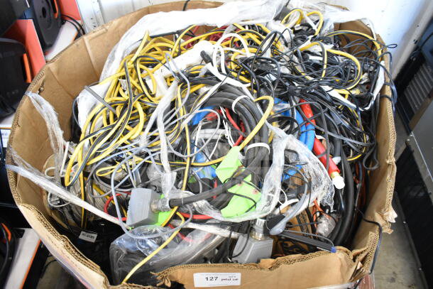 Lot of various cables and items in a large cardboard box, mixed condition, includes power and audio cables, item label "127."