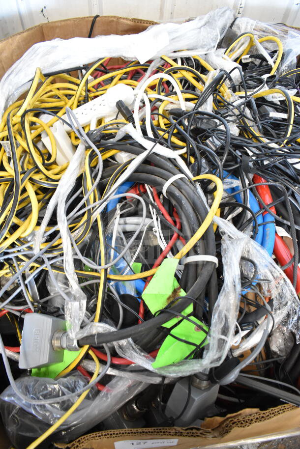 Lot of various cables including yellow, black, and red cords, power strips, and connectors in mixed condition.