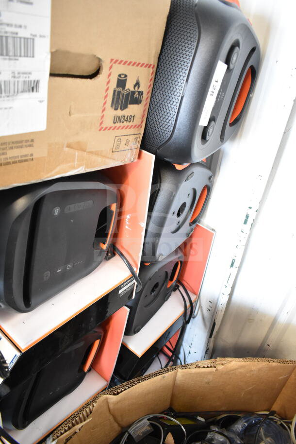 Stack of six JBL speakers for store display, boxed and wrapped. Includes power cords, excellent condition, marked UN3481 for batteries.