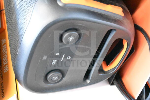 JBL Partybox speaker display, featuring control buttons and branded packaging. New condition with visible logos.