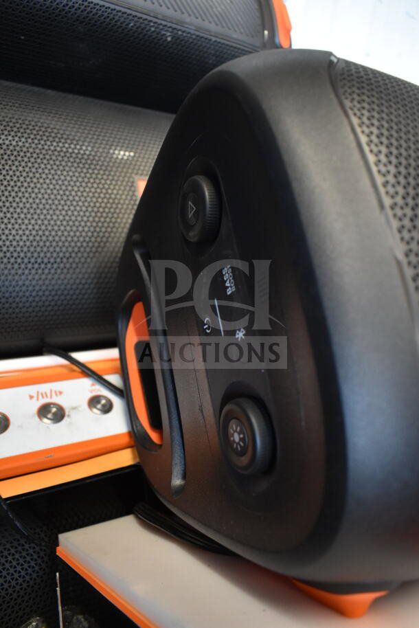 JBL speaker in store display, featuring control knobs, bass boost, Bluetooth, and a durable handle. Excellent condition.