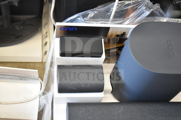Store display featuring ONN 5.1.2 surround soundbar system with subwoofer and satellite speakers in good condition.