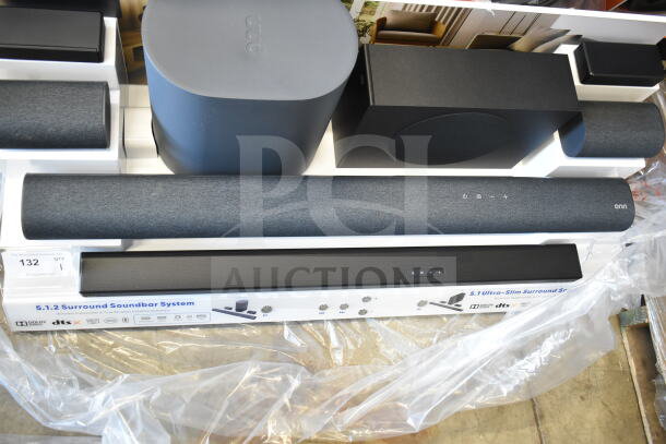 5.1.2 Surround Soundbar System display in packaging, includes soundbar, subwoofer, and satellite speakers, model details visible.