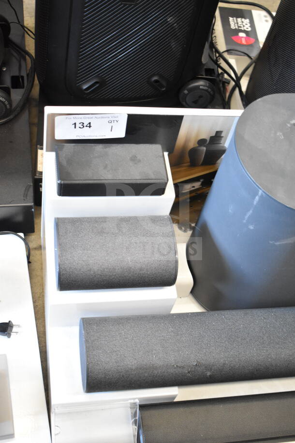Store display of 5.1.2 surround soundbar system with multiple speakers; minor wear visible.