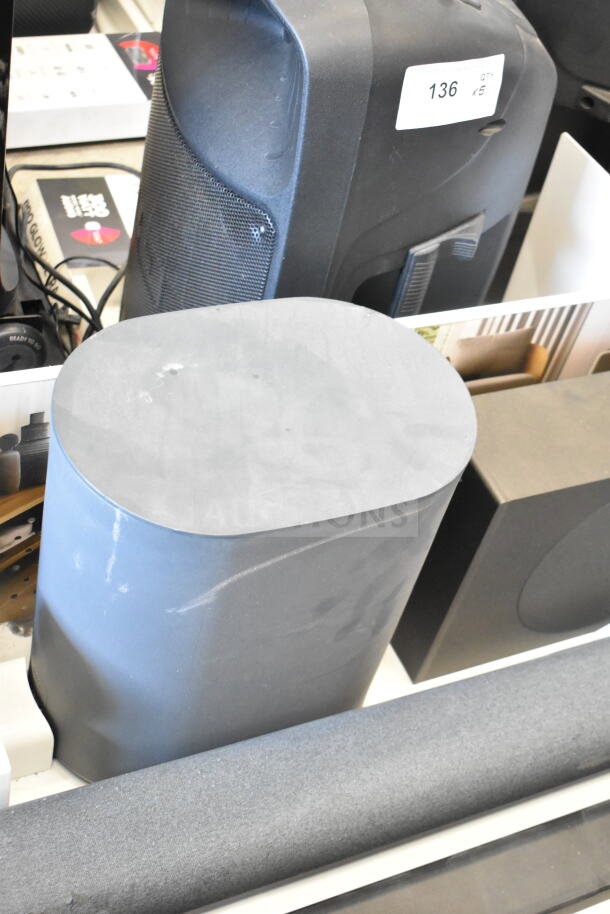 Store display featuring a 5.1.2 surround soundbar system, shown with speakers and subwoofer, in good condition, with item tag 136.