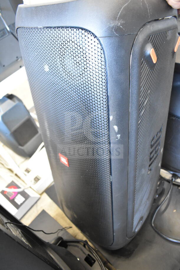 JBL Partybox 310 speaker in store display, slightly used with minor scuffs, features vibrant sound and portability.