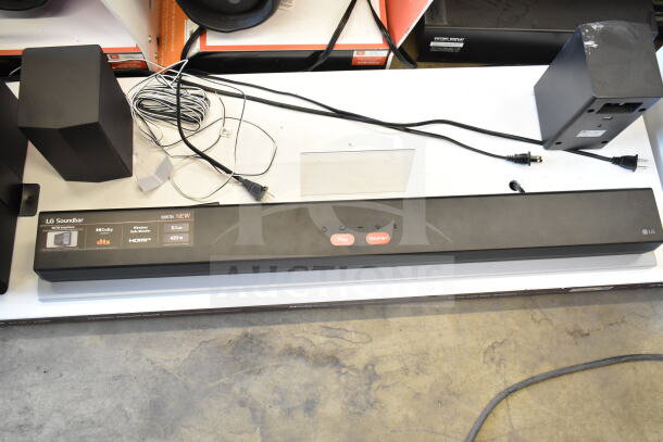 LG sound bar display with 4 speakers, model S55TR. Features Dolby, DTS, 5.1 channel, HDMI, 420W. Appears in good condition.