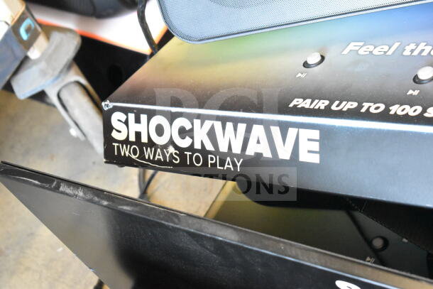 Altec Lansing Shockwave speaker display with "Two Ways to Play" sign, featuring functionality details.