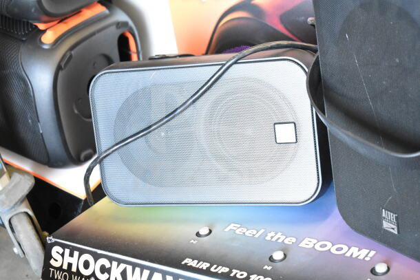 Altec Lansing Shockwave speaker display, intact. Promotes "2 times your bid" offer. Features "Feel the BOOM" branding.