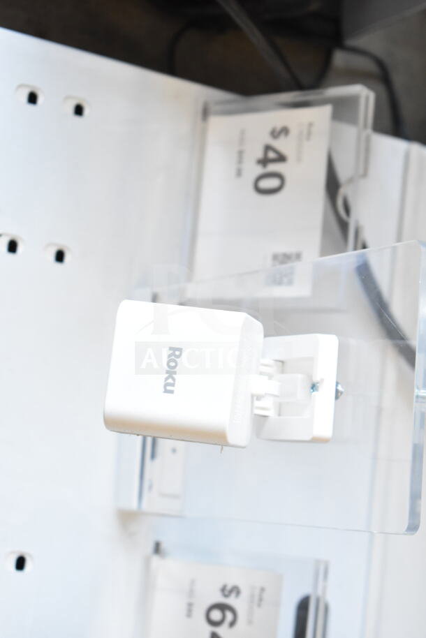 Store display featuring a mounted Roku camera, priced at $40; displayed on a clear acrylic stand.
