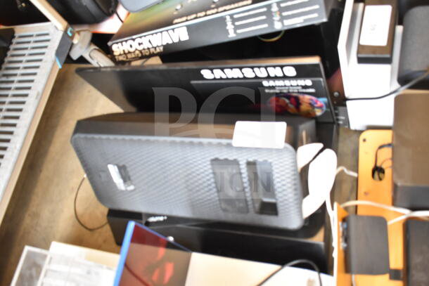 3-store display of Ion speaker, Onn medium party speaker, and Samsung speaker. Features visible packaging.