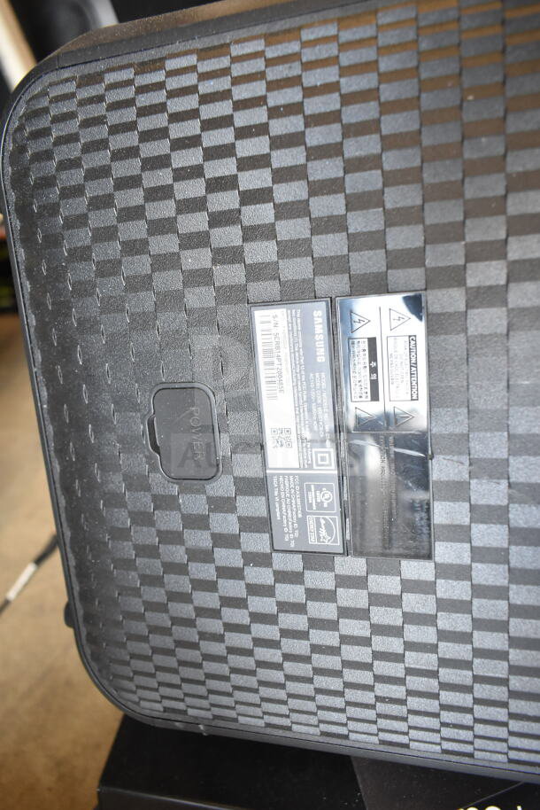 Three-store display with Ion speaker, Onn medium party speaker, and Samsung speaker. Labels with specs visible.