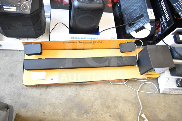 Vizio sound bar and speaker display. Features "Powerful Surround Sound" label. Includes cords. Condition is shown in photo.