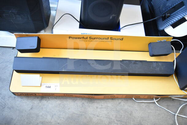 Vizio sound bar and speaker display, showcasing "Powerful Surround Sound." Includes labeling and connection wires visible.