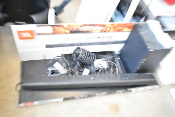 JBL sound bar and speaker set store display, includes cables and packaging, model SB580. Slight wear visible.