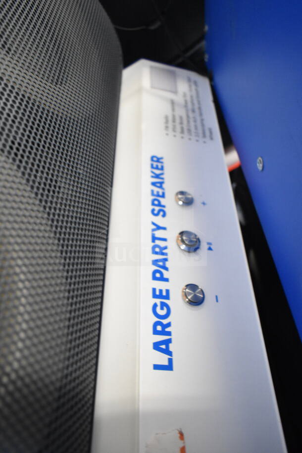 Onn Large Party Speaker display, featuring a sleek grid pattern and prominent control knobs. Visible text: "LARGE PARTY SPEAKER."