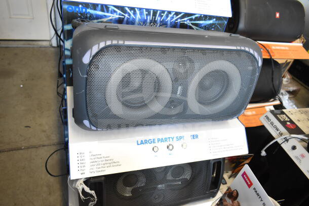 Onn Large Party Speaker on store display, showcasing dual woofers and control panel. Features include Bluetooth and LED effects.