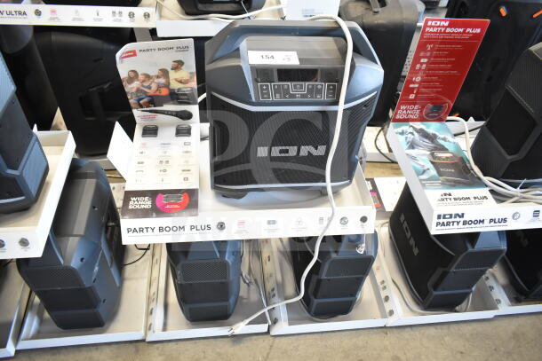 ION Party Boom Plus speakers on display, featuring Bluetooth capability. Includes microphone input and wide-range sound.