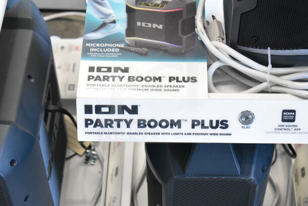 ION Party Boom Plus speaker display, featuring portable Bluetooth-enabled speakers with lights, microphone included.