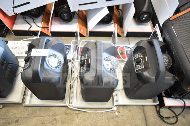3 Ion Party Rocker Max speakers on display, featuring built-in party lights, black finish, excellent condition, lot label 157 x3.