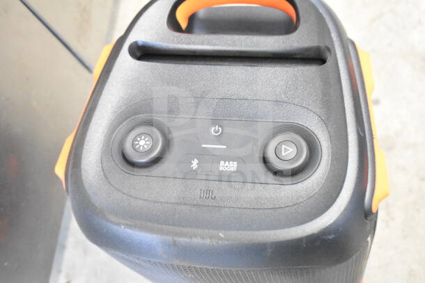 JBL speaker with controls: power, Bluetooth, bass boost. Black, orange accents, excellent condition, part of a display set.