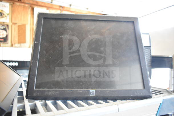 Three used computer monitors: elo, Dell, LG. Visible wear and fingerprints on screens. Auction bundle, 3x your bid offer.