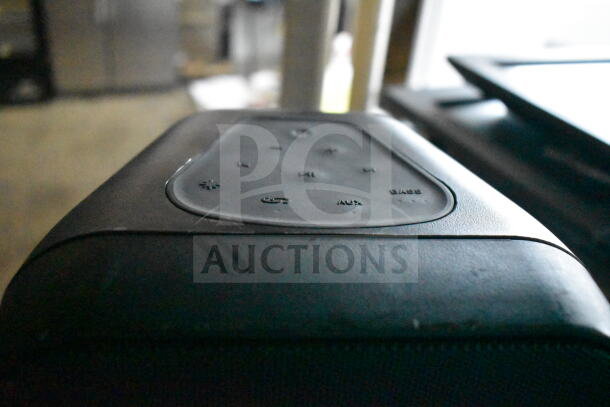 Altec Lansing speaker, black, with visible control panel featuring power, volume, AUX, and bass buttons, in good condition.