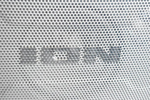Close-up of the Ion Speaker's front grille, showing a modern design pattern. The brand logo is subtly visible.