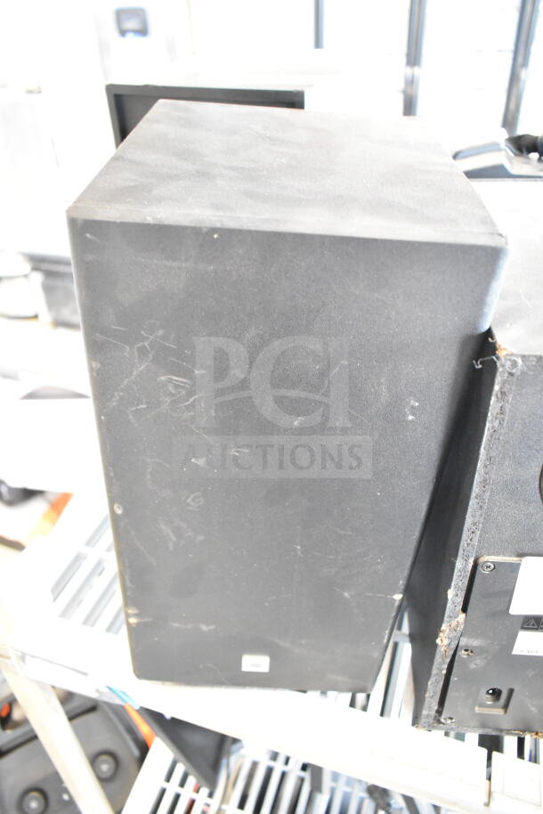 Three speakers, including Samsung PS-WR45BB and Anatel Cinema SB580, in used condition, with visible scratches and wear.