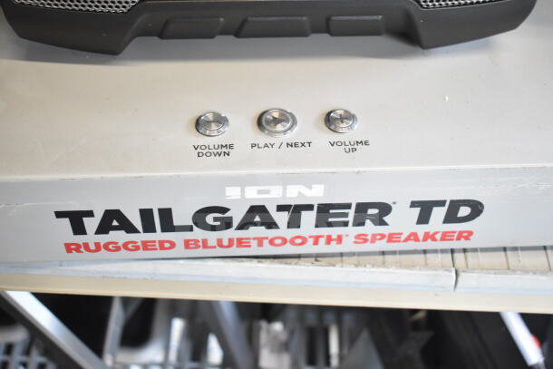 Ion Tailgater TD rugged Bluetooth speaker with volume and play controls. Visible brand logo and speaker grille.