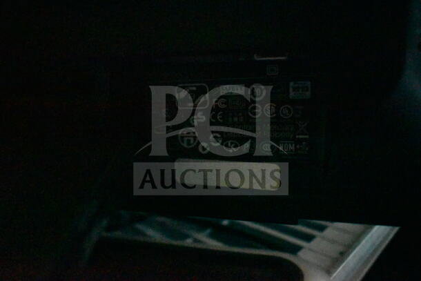 7 assorted monitors including Dell, varying models. Visible labels include safety certifications and mercury warning.