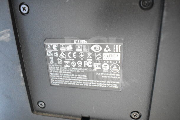Close-up of a monitor label showing model E1715Sc, various safety symbols, and manufacturer info, Top Victory Electronics.