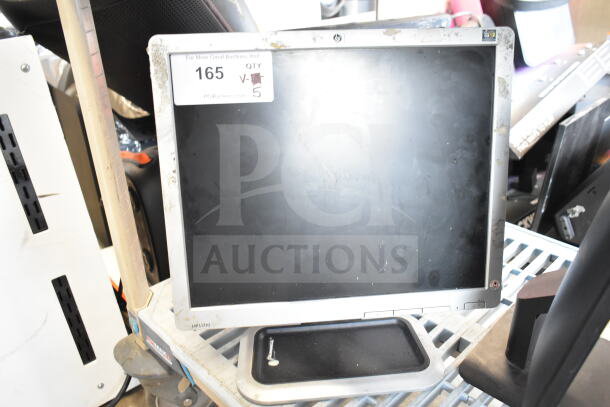 Various monitors including Dell and Sanyo, lot of 5, mixed condition. Includes HP L1710 with visible wear. Auction tag QTY 5.