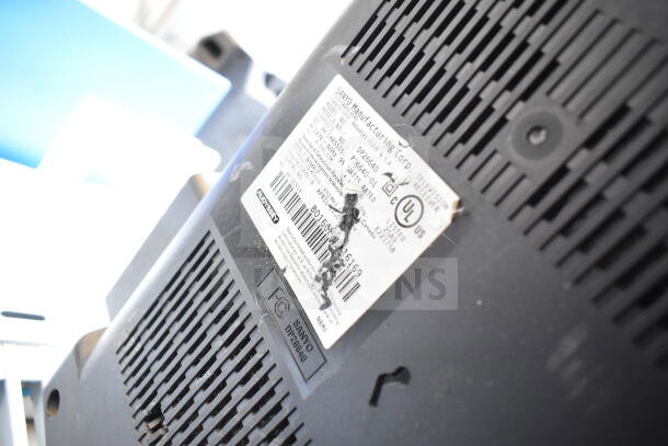Close-up of a Sanyo monitor's label, model DP26640, showing specifications and FCC markings. Part of a 5-monitor auction lot.