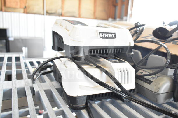 Hart CGH006 battery charger with visible logo atop gray metal grid shelf, includes attached cords.