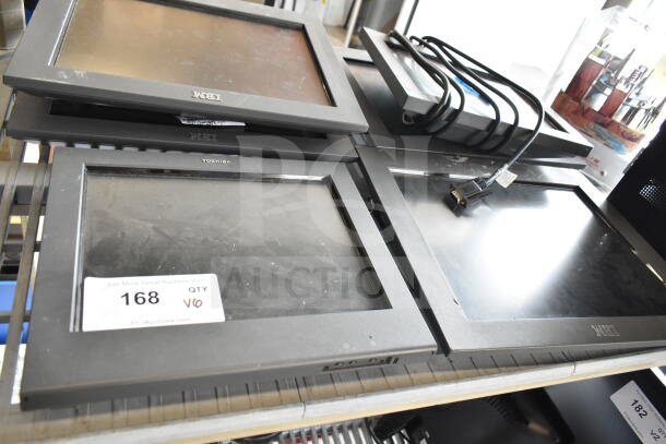 Six assorted monitors including IBM and Toshiba, stacked. Visible wear. Auction tag shows "168 QTY V6."
