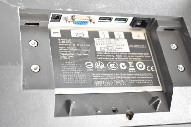 Back of an IBM monitor showing ports and labels. Features VGA port, USB ports. Certified in Taipei, Taiwan. Model and specs visible.