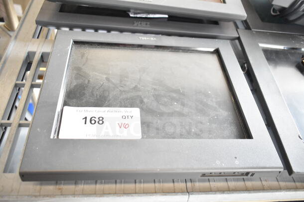 6 various monitors including IBM and Toshiba, stacked, visible wear. Tag reads: "168, QTY V6, PCI Auctions."