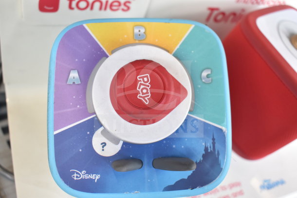 Store display with Disney-themed Tonie Box; colorful design, play button, visible A, B, C markings; shows slight wear.
