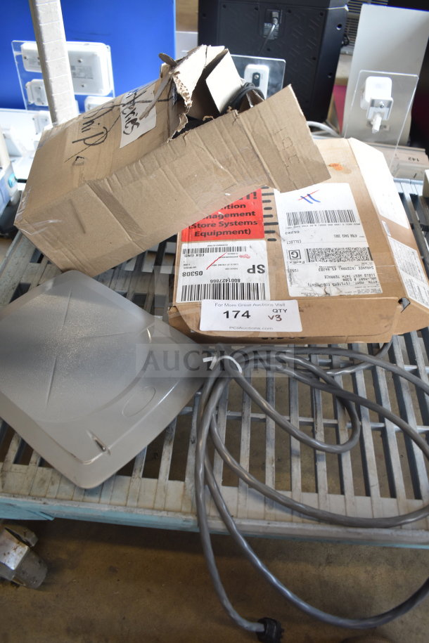 Three assorted items including a Sensormatic ZBSMPCPEF panel, telephone, and cables. Items show wear with visible packaging.