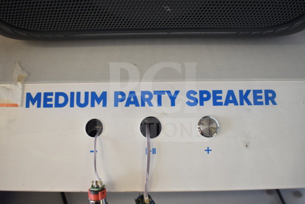Onn Medium Party Speaker display with control markings for volume and play. Features durable grille and minimalist design.