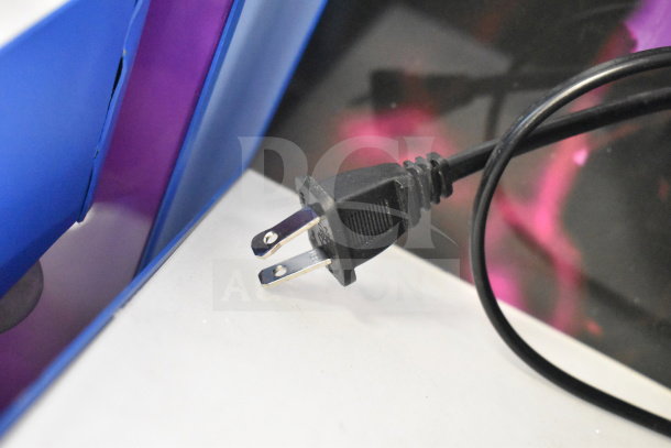 Power cord connected to Onn Medium Party Speaker display, featuring vibrant blue and purple design.